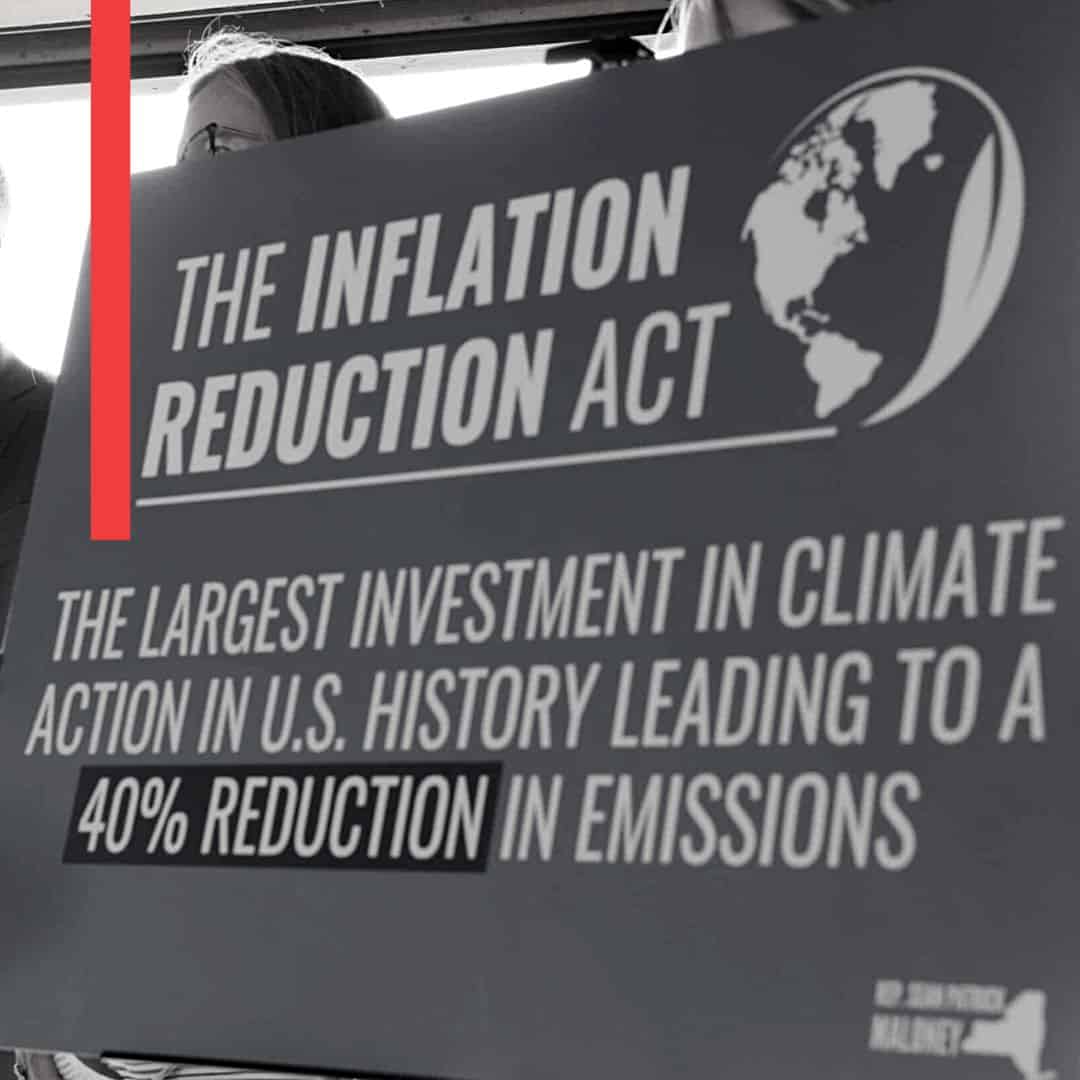 a sign about the inflation reduction act reads "the largest investment in climate action in U.S. history leading to a 40% reduction in emissions"
